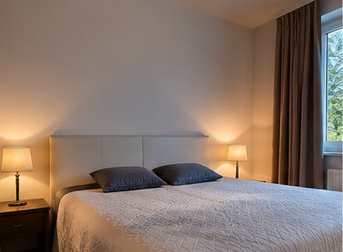 Bedroom before editing, with a warm yellow lamp glow