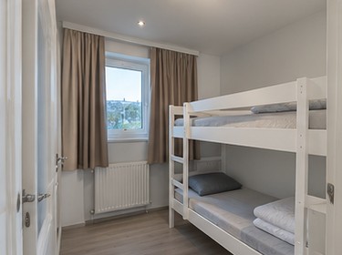 The same bunk bed room after editing, bright and open