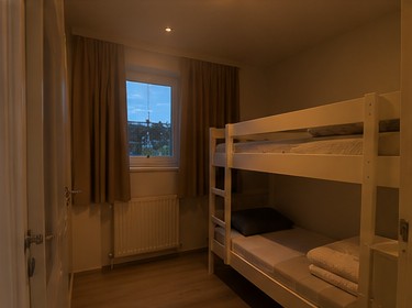 Bunk bed room before editing, dark with heavy shadows